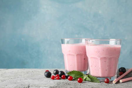 Delicious berry milkshakes on gray table. Summer drinkの写真素材