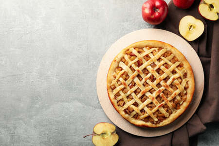 Composition with apple pie and ingredients on gray background, top viewの写真素材