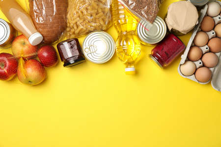 Different food on yellow background, top view. Donation conceptの写真素材