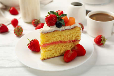 Composition with delicious berry cream cake on white wooden table. Tasty dessertの写真素材
