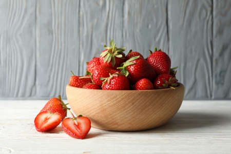 Bowl with tasty strawberry on wooden table. Summer berryの写真素材