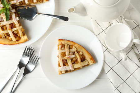 Composition with apple pie on white wooden background. Tasty lunch. Homemade breakfast