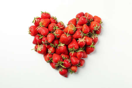 Heart made of tasty strawberry on white background, top view. Summer berryの写真素材