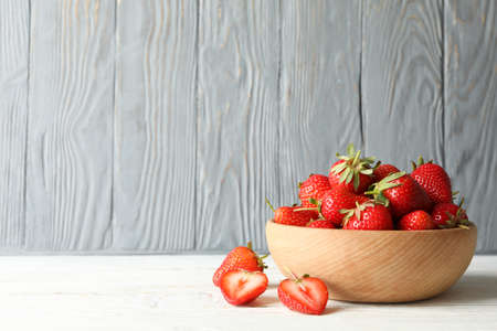 Bowl with tasty strawberry on wooden table. Summer berryの写真素材