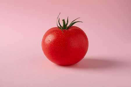 Fresh ripe tomato on pink background, close upの写真素材