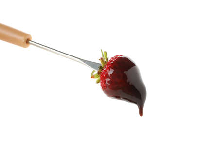 Chocolate fondue. Strawberry in chocolate sauce isolated on white backgroundの写真素材