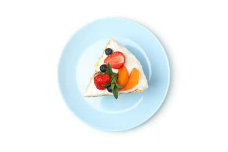 Plate with berry cream cake isolated on white background