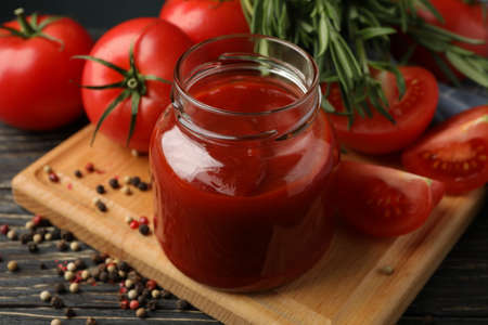 Composition with tomatoes and sauce on wooden background. Ripe vegetableの写真素材