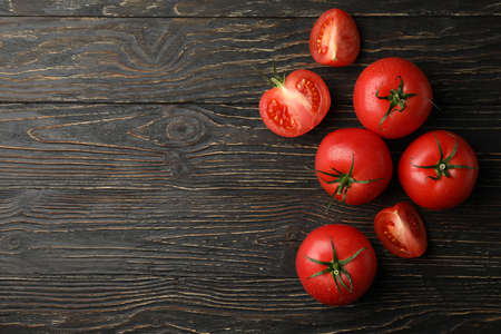 Fresh ripe tomatoes on wooden background, top viewの写真素材