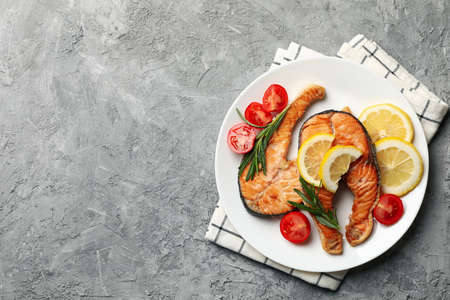 Composition with tasty grilled salmon on gray background, top viewの写真素材