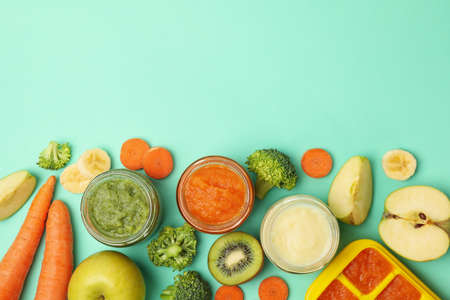 Composition with baby food on mint background, top viewの写真素材