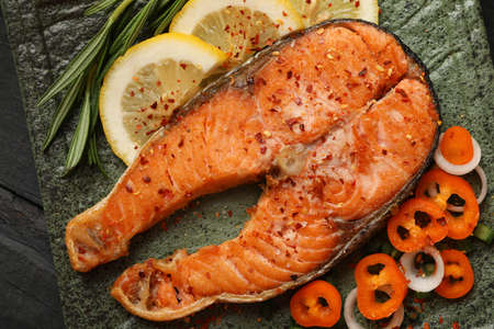 Composition with tasty grilled salmon on wooden background, close upの写真素材