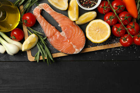 Composition with salmon meat and spices on wooden background, top viewの写真素材