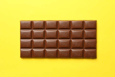 Tasty chocolate bar on yellow background. Sweet foodの写真素材
