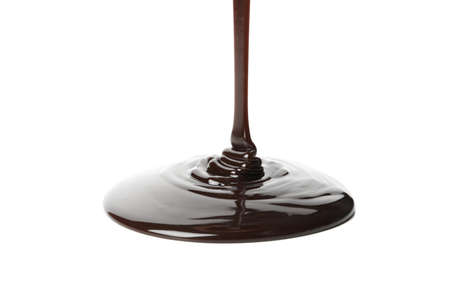 Melted chocolate is pouring, isolated on white background