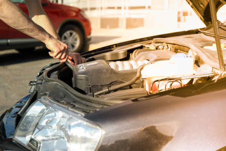 Man fixing engine. Car inspection. Work of mechanicの写真素材
