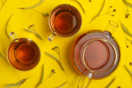 Composition with linden tea on yellow background, top view. Natural teaの写真素材