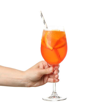 Female hand holding glass of aperol cocktail, isolated on white backgroundの写真素材