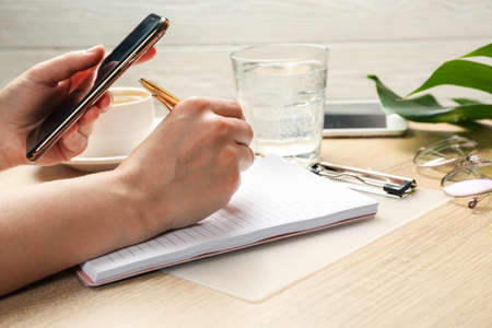 Girl writes in a notebook. Business or blogger concept