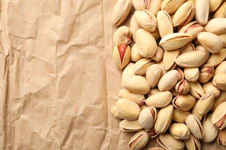 Tasty pistachio on baking paper background. Vitamin food