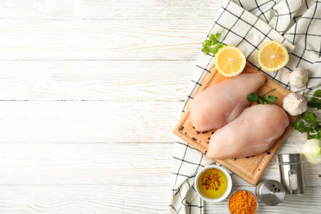 Composition with raw chicken meat on wooden background, top viewの写真素材
