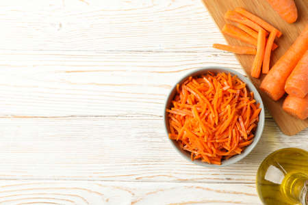 Composition with carrot salad on white wooden table. Cooking korean carrotの写真素材
