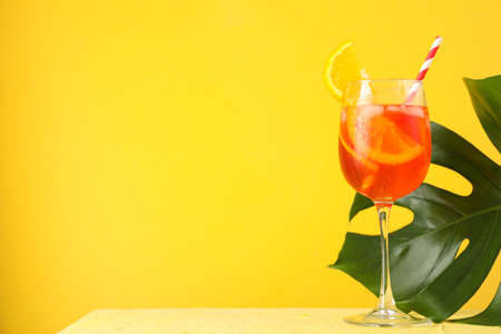 cocktail and palm leaf on yellow background. Summer drinkの写真素材