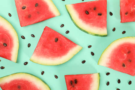 Composition with fresh watermelon slices on mint background, top viewの写真素材