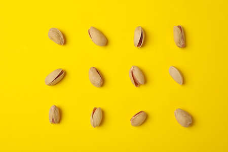 Flat lay with pistachio on yellow background. Vitamin food