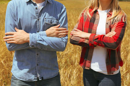 Young man and woman in barley field. Agricultureure businessの写真素材