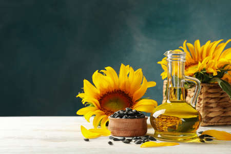 Composition with sunflower, seeds and oil on white wooden backgroundの写真素材