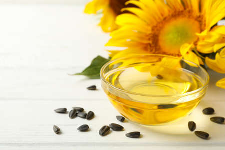 Sunflower, seeds and oil on white wooden backgroundの写真素材