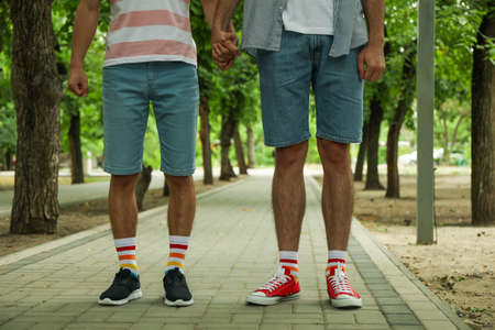 Gay couple in LGBT socks standing together outdoor