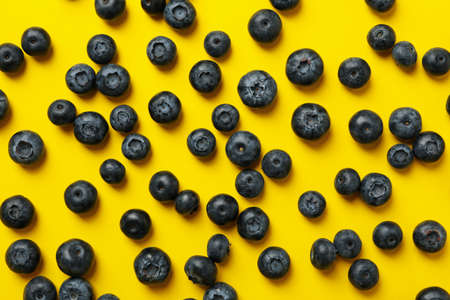 Delicious fresh blueberry on yellow background, top viewの写真素材
