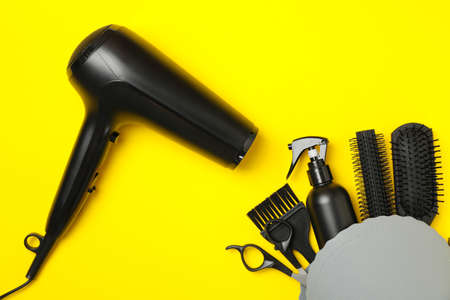 Composition with hairdresser accessories on yellow background, top viewの写真素材