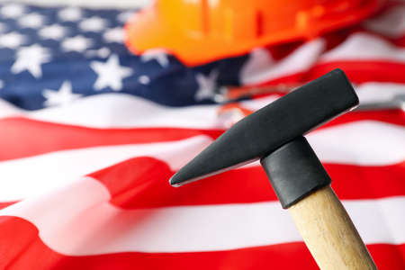 Safety helmet and hammer on american flag background, space for textの写真素材