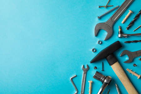 Construction tools on blue background, space for text