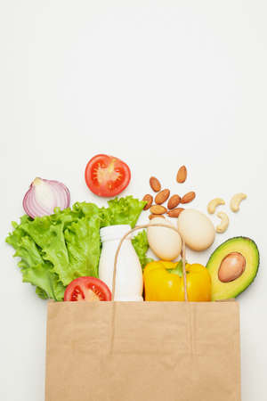 Paper bag with different food on white backgroundの写真素材