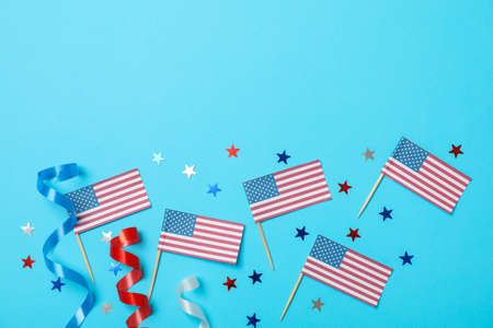 American flags, curly ribbons and stars on blue background