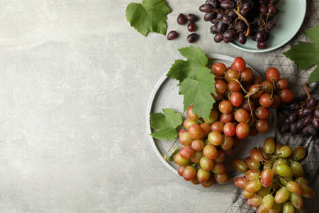Composition with grape and towel on gray background