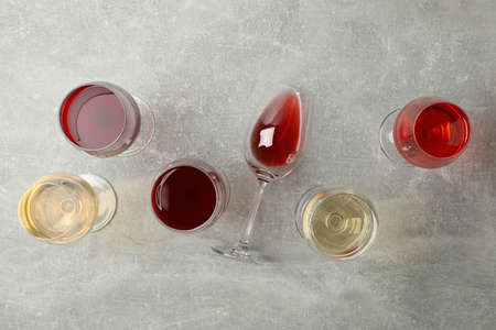 Glasses of wine on gray background, top viewの写真素材