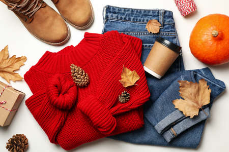 Autumn concept with sweater and jeans on white backgroundの写真素材