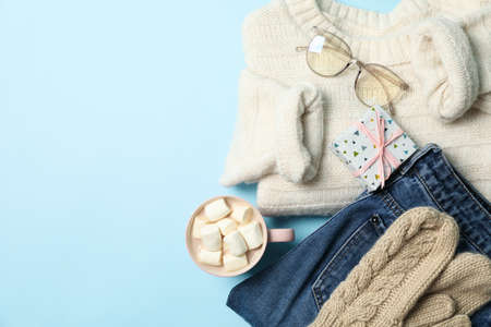 Winter concept with sweater and gift box on blue backgroundの写真素材