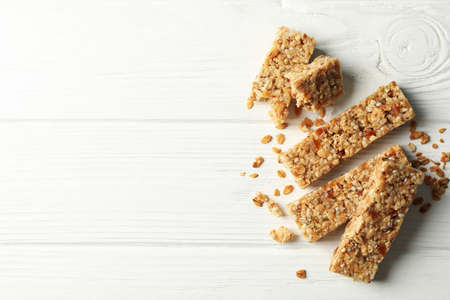 Tasty granola bars on white wooden backgroundの写真素材