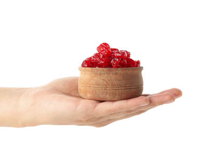 Female hand hold bowl of dried cherry, isolated on white backgroundの写真素材