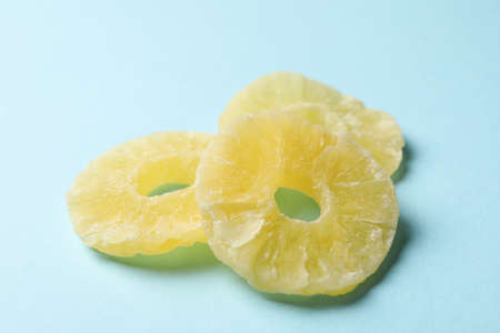 Tasty dried pineapple slices on blue backgroundの写真素材