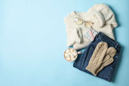 Winter concept with sweater and gift box on blue backgroundの写真素材