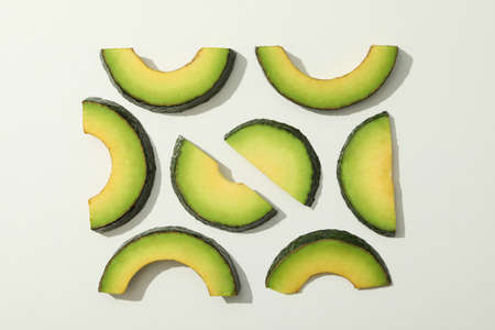 Fresh green avocado slices on white backgroundの写真素材