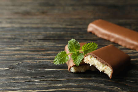 Mint and coconut bars in chocolate on wooden backgroundの写真素材