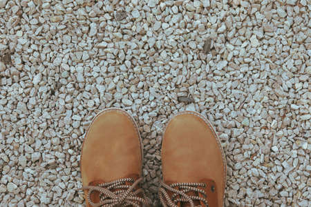 Boots on stones background, top view and space for textの写真素材